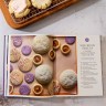 Picture of 108 Asian Cookies open to a page showing a variety of colorful cookies next to the heading "Silk Road Sweets"